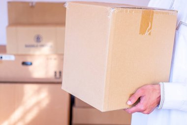 Arap adam elinde karikatür kutusu tutuyor.