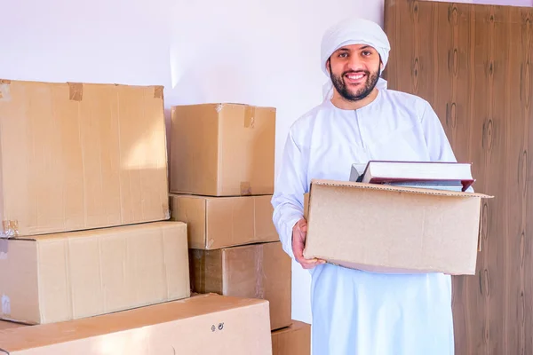 Arabic man holding box of cartoon
