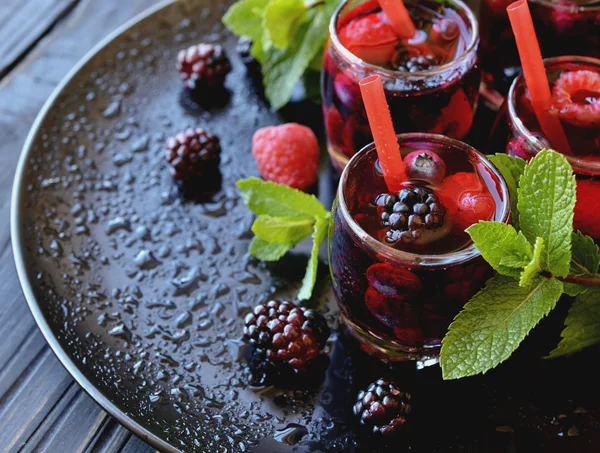 berry juice in a glass with berries, selective focus