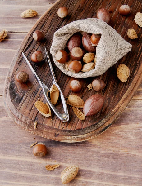 Canvas bag with nuts on a wooden table — Stock Photo, Image