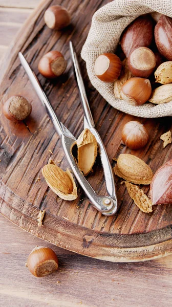 Canvas bag with nuts on a wooden table — Stock Photo, Image