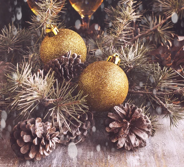 Christmas balls with fir branches and glasses of champagne — Stock Photo, Image