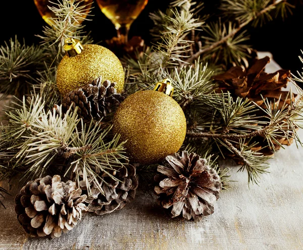 Christmas balls with fir branches and glasses of champagne — Stock Photo, Image