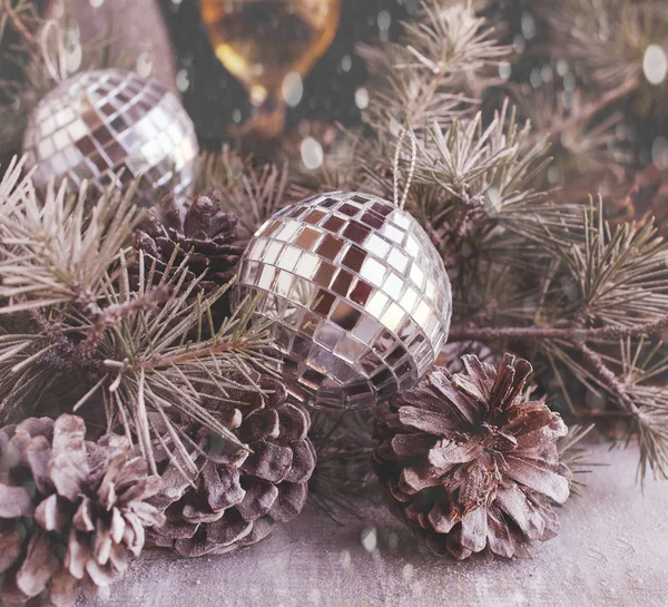 Christmas balls with fir branches and glasses of champagne — Stock Photo, Image