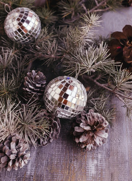 Christmas balls with fir branches and glasses of champagne — Stock Photo, Image