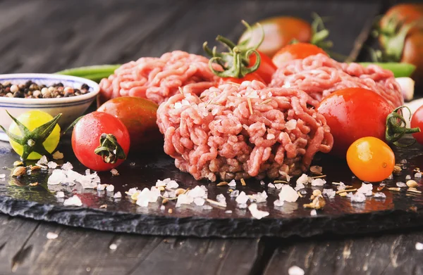 Raw minced meat, vegetables with salt and spices, selective focus — Stock Photo, Image
