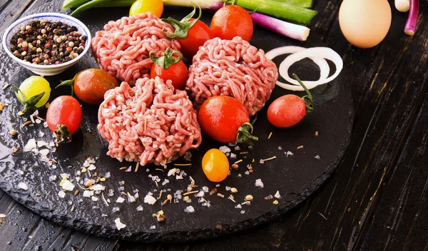 Сырое мясо, овощи с солью и специями, избирательное внимание — стоковое фото
