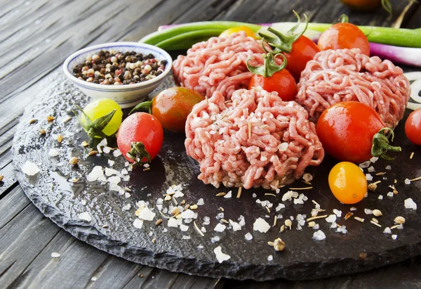 Raw minced meat, vegetables with salt and spices, selective focus — Stock Photo, Image