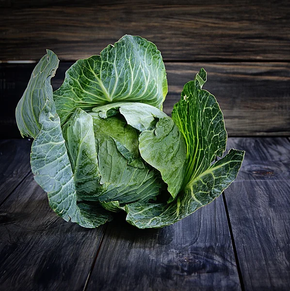 Head of cabbage a wooden background — Stock Photo, Image