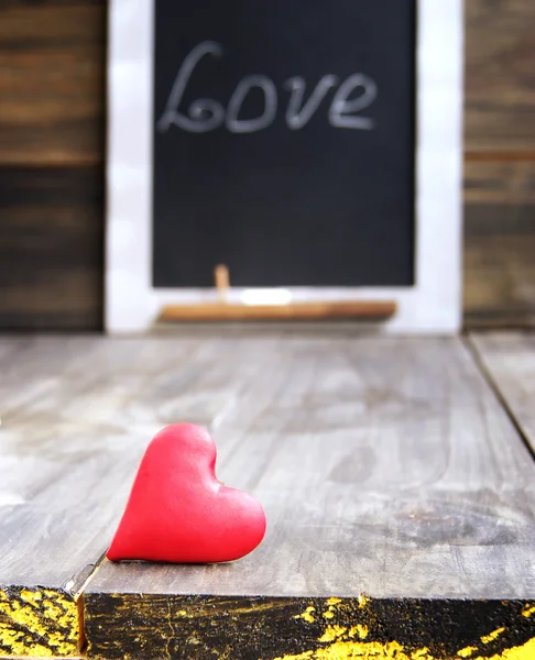 Small hearts on a wooden background — Stock Photo, Image