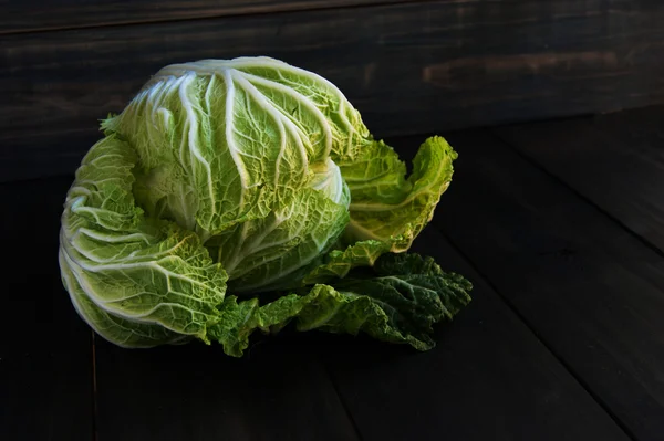 Cabbage on a black wooden boards — Stock Photo, Image