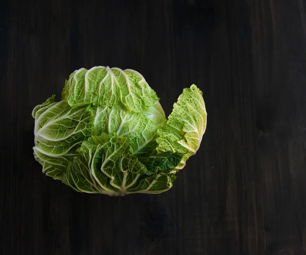 Cabbage on a black wooden boards — Stock Photo, Image