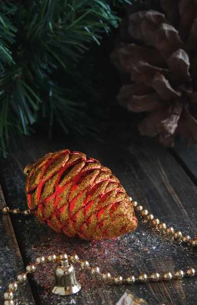 Christmas decorations on a background of trees and cones — Stock Photo, Image