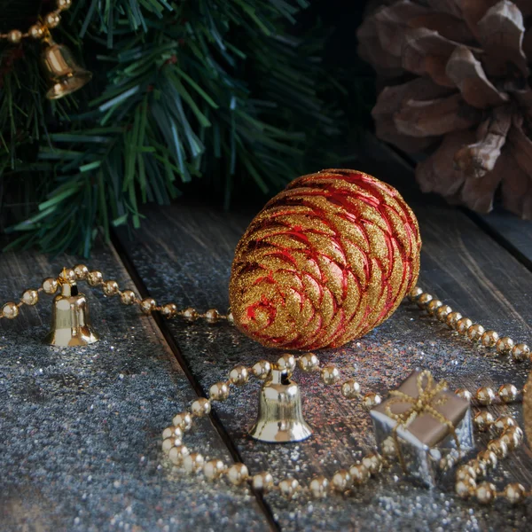 Christmas decorations on a background of trees and cones — Stock Photo, Image