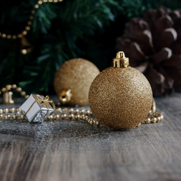 Christmas decorations on a background of trees and cones — Stock Photo, Image