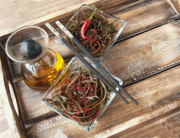 Seaweed and chopsticks, on an open wooden table — Stock Photo, Image