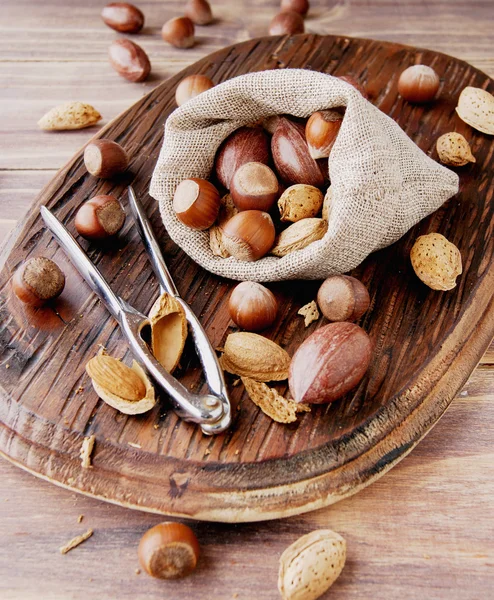 Canvas bag with nuts on a wooden table — Stock Photo, Image