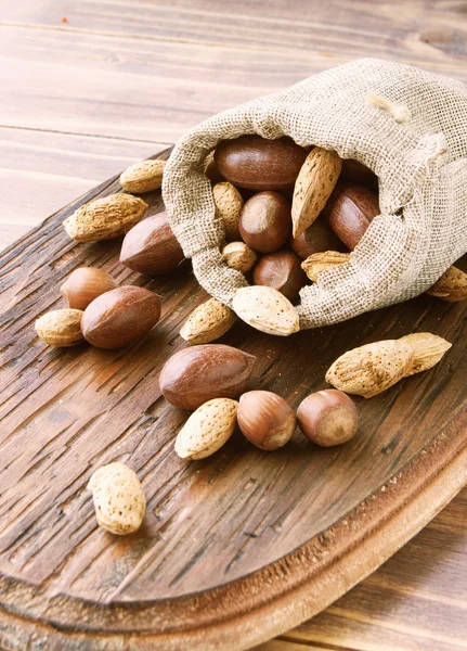 Canvas bag with nuts on a wooden table — Stock Photo, Image