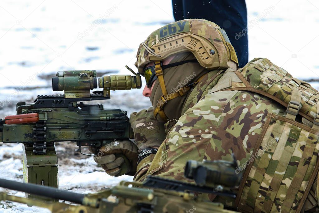Poltava, Ukraine - March 6, 2021: Fighters of the Security Service of Ukraine (SBU, ukrainian: ) with a machine gun during training in the field in winter