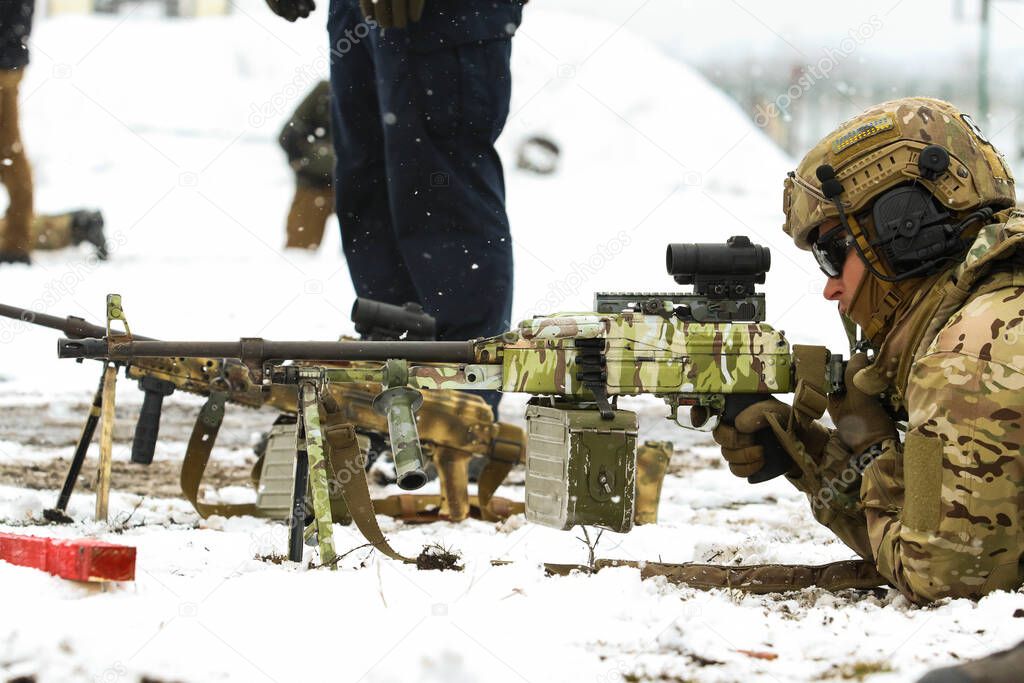 Poltava, Ukraine - March 6, 2021: Fighters of the Security Service of Ukraine (SBU, ukrainian: ) with a machine gun during training in the field in winter