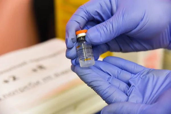Poltava, Ukraine - 21 July, 2021: Ampoule of the vaccine from COVID-19 CoronaVacSinovac Biotech in the hands of a doctor