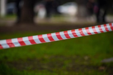 Yeşil çimlerin arka planında kırmızı ve beyaz koruyucu bant