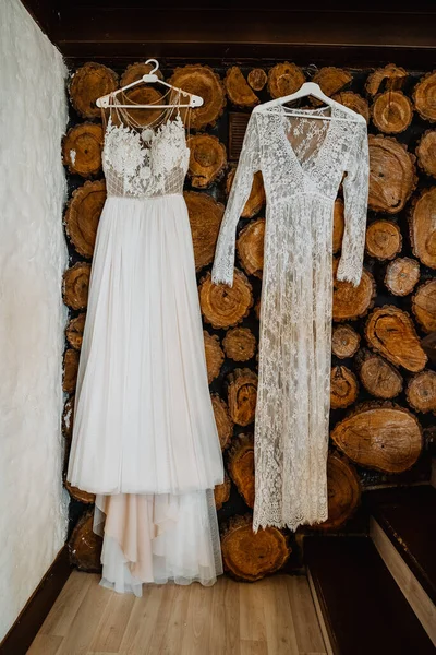 two boho style bridesmaid dresses hang on a hanger, beautiful wedding dress for wedding, morning bride