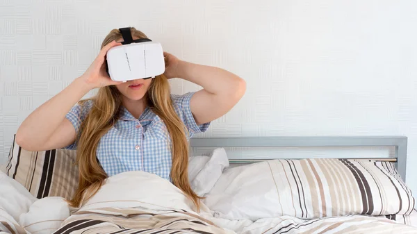 Hermosa mujer usando auriculares VR en la cama — Foto de Stock