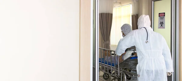 Medical staff pushing a patient trolley of a COVID-19 ill into the separation room.