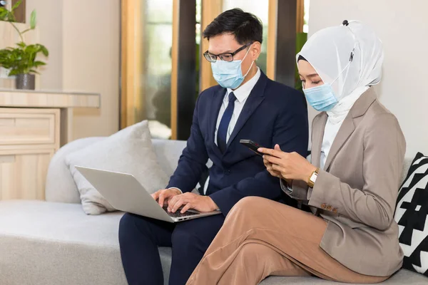 Young working people are preparing information before meeting customers on the sofa.