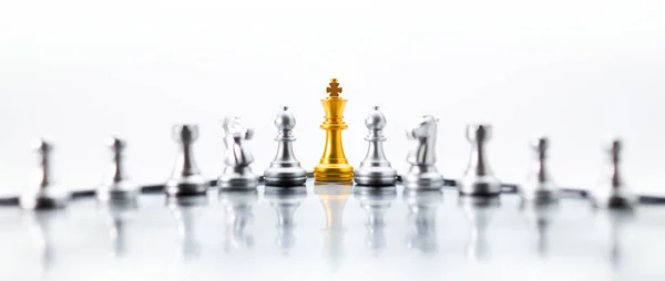 Concept of leadership. Golden king chess on the board on white background. Abstract images show business leadership.