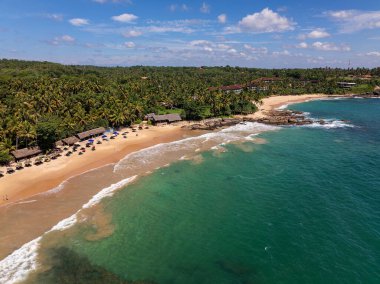 Goyambokka Sahili, Sri Lanka 'da Yüzücülerin ve Altın Kum üzerindeki Thatched Sahil Kulübelerinin Hava Görüntüsü