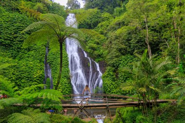 Bambu Köprüsünde Duran Kadın Banyumala Şelalesi, Bali, Endonezya