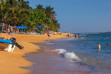 Unawatuna Plajı 'nda güneşli bir gün Sahilde yüzen Turistlerle, Sri Lanka
