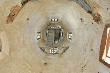 Pencereleri ve merdivenleri olan terk edilmiş ve ihmal edilmiş bir kulenin içi..