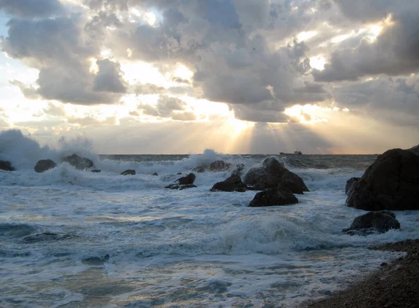 Cloudy landscape clouds and sun rays shining through the clouds, storm on the sea.