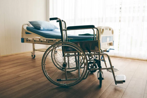 Wheelchair and beds for patients, in rooms with light passing through white curtains in the daytime, to health and insurance concept.