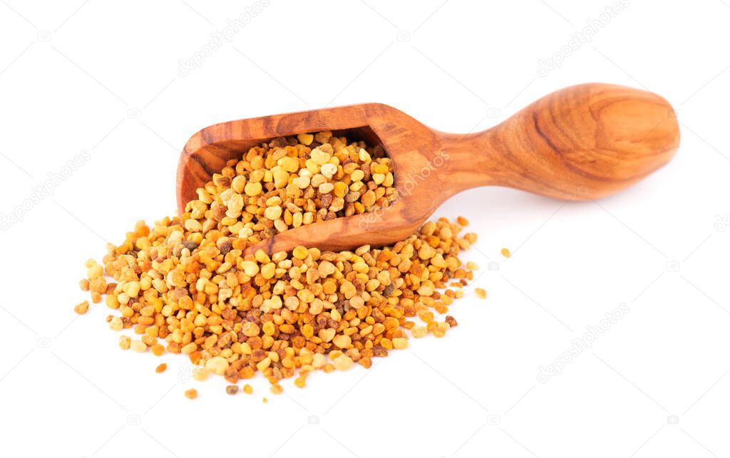 Flower pollen grains in wooden scoop, isolated on white background. Pile of bee pollen or perga