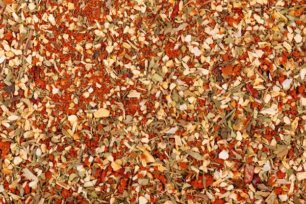 Mix of herbs, spices and dry tomatoes, background. Natural organic food seasoning