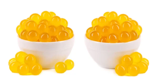 Yellow tapioca pearls for bubble tea isolated on white background. Tapioca pearls in ceramic bowl. — Stock Photo, Image