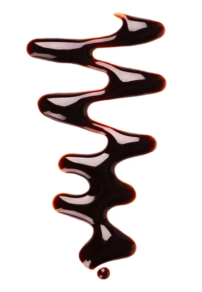 Arroser de sirop de chocolat isolé sur fond blanc. Des éclaboussures de sauce au chocolat. Vue du dessus. — Photo