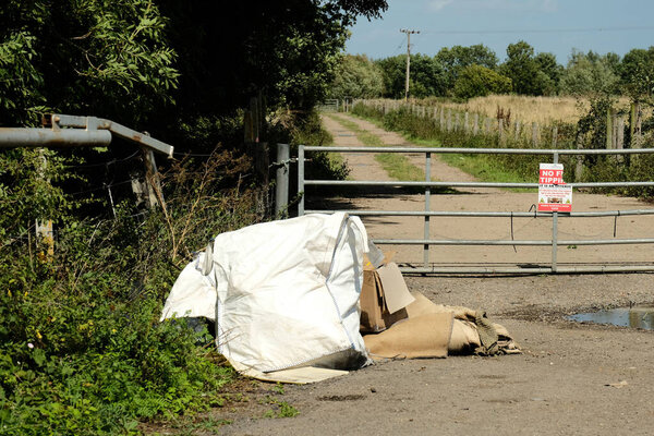 Fly tipped bags on a country lane