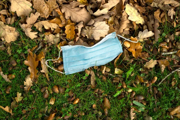 Discarded blue face mask image