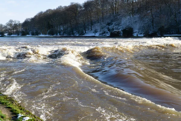 Strong current over a river weir