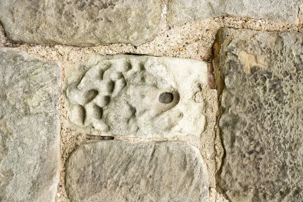 Soft stone wall showing signs of erosion