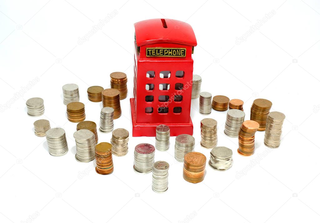 Red money box with stacks of coins