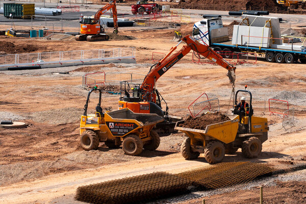 Yellow dumper trucks on a construction site