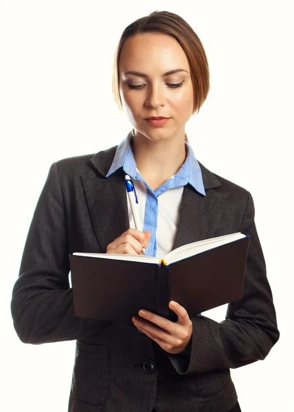 Junge Geschäftsfrau schreibt in ihrem Organisator — Stockfoto