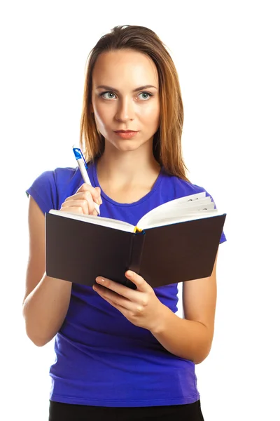 Young woman writing in her organizer — Stock Photo, Image