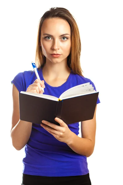 Young woman writing in her organizer — Stock Photo, Image